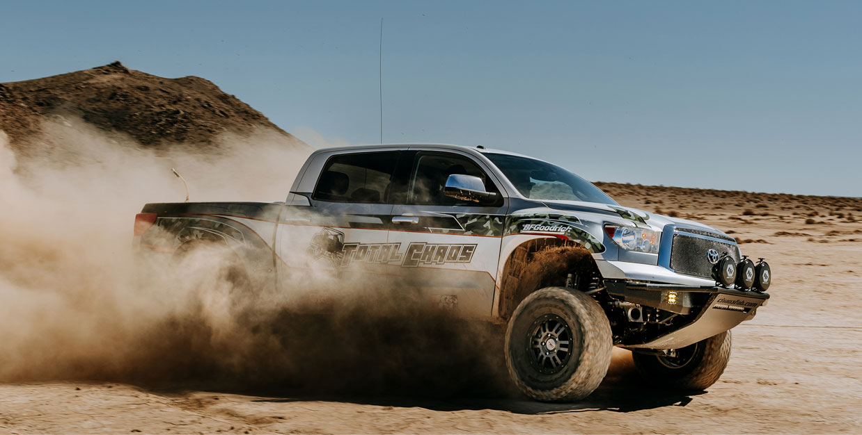 off road truck driving through the sand