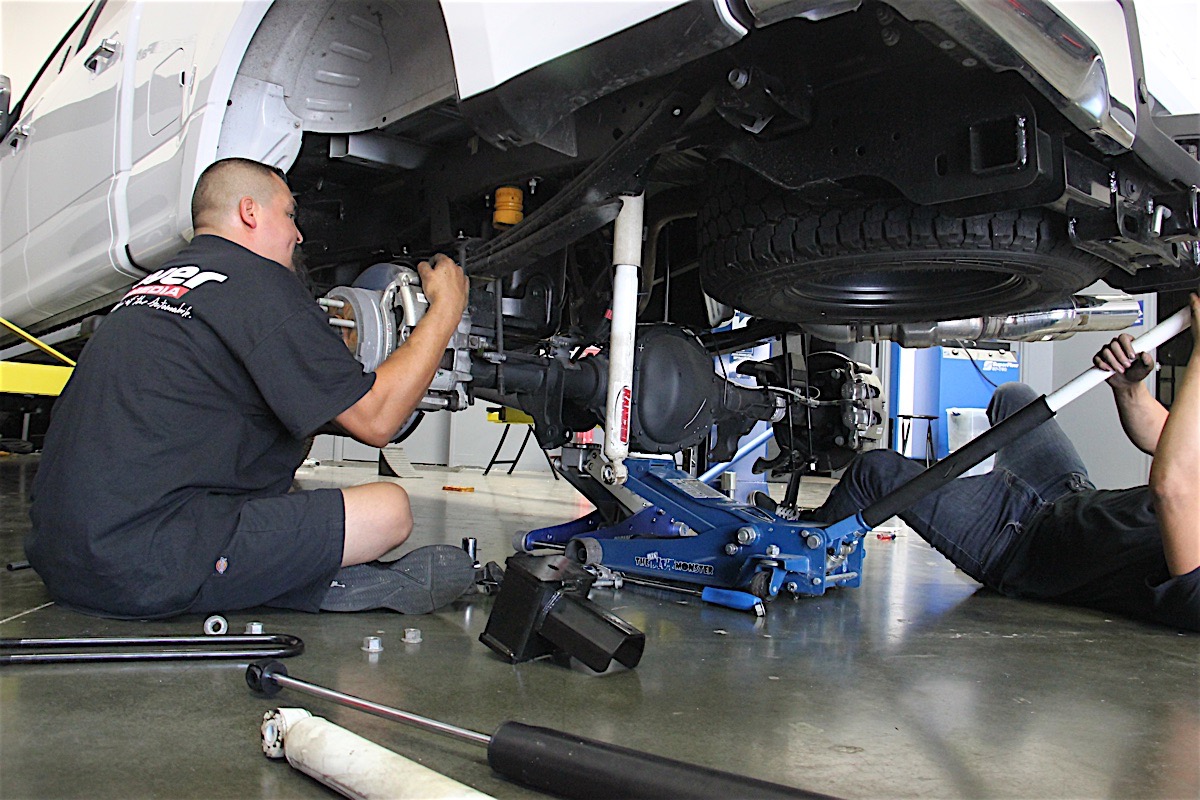 mechanic working on truck suspension